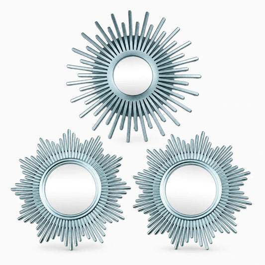 Miroir mural doré en forme de soleil avec rayons stylisés sur fond blanc